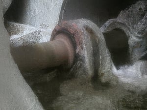 Deteriorated metal pillow block bearing before replacement